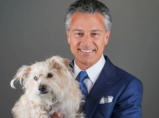 Mike Morse holding a small white rescue dog