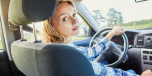 Teen putting herself and other passengers in danger while driving and looking away of the road