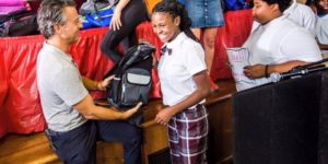 Mike Morse giving a backpack to a girl during Backpack Project happening in schools