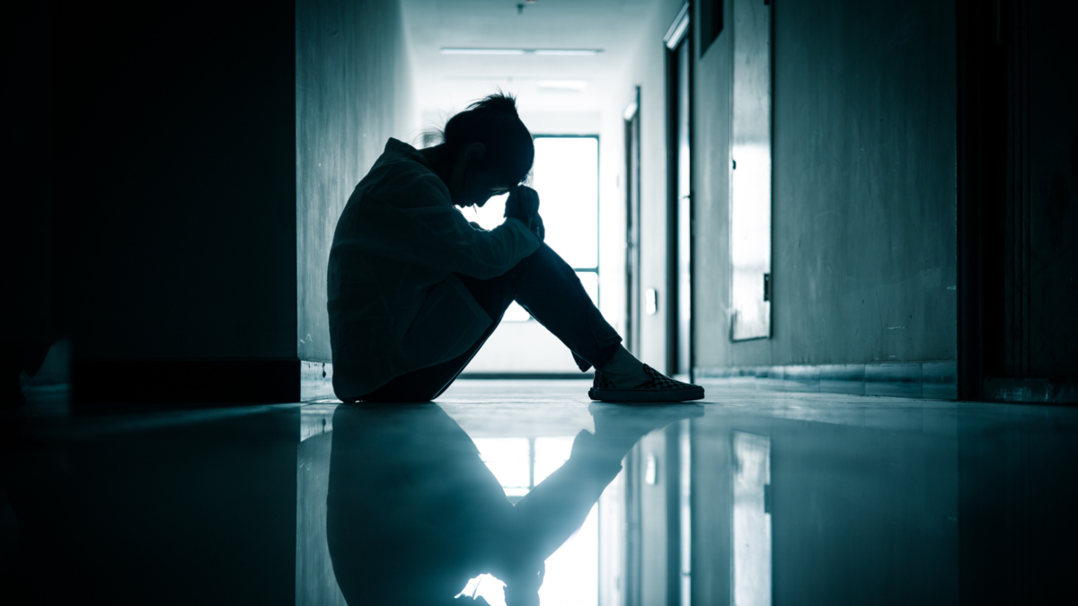 person with ptsd in hallway of a clinic