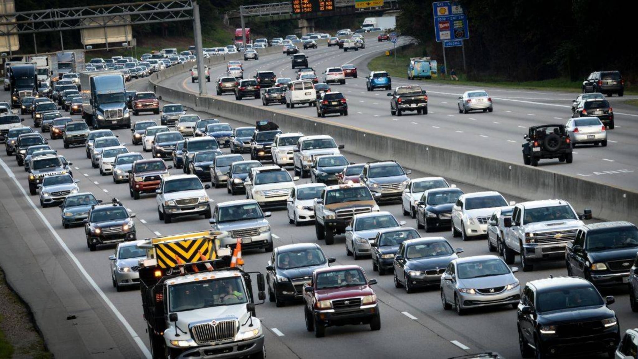 A multi-lane highway with traffic in one way.